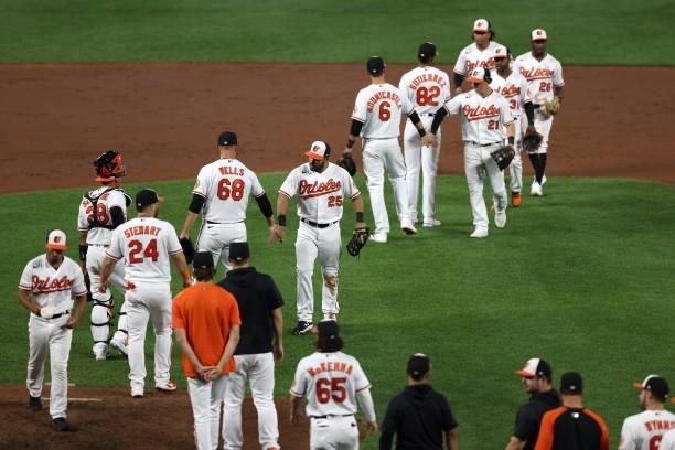 Members of the Baltimore Orioles celebrate their 7-3 win over the Kansas City Royals at Oriole Park at Camden Yards on September 07, 2021 in...
