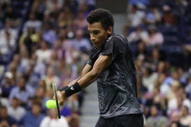 Felix Auger-Aliassime of Canada reaches to return the ball against Carlos Alcaraz of Spain during his Men’s Singles quarterfinals match on Day Nine...