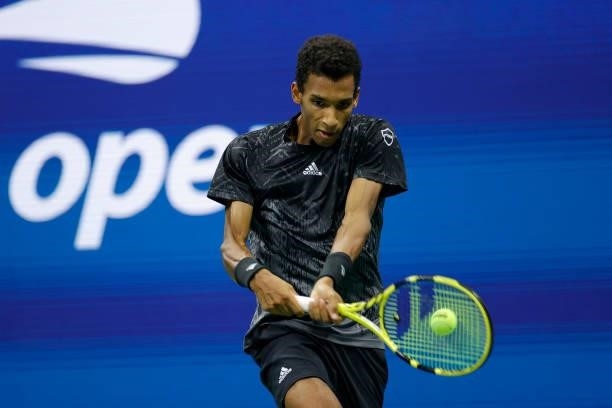 Felix Auger-Aliassime of Canada reaches to return the ball against Carlos Alcaraz of Spain during his Men’s Singles quarterfinals match on Day Nine...