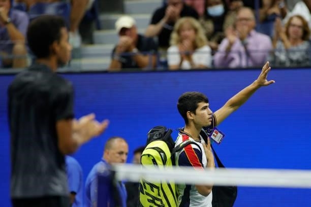Carlos Alcaraz of Spain looks waves to the crowd as he leaves the court after retiring during his Men’s Singles quarterfinals match against Felix...
