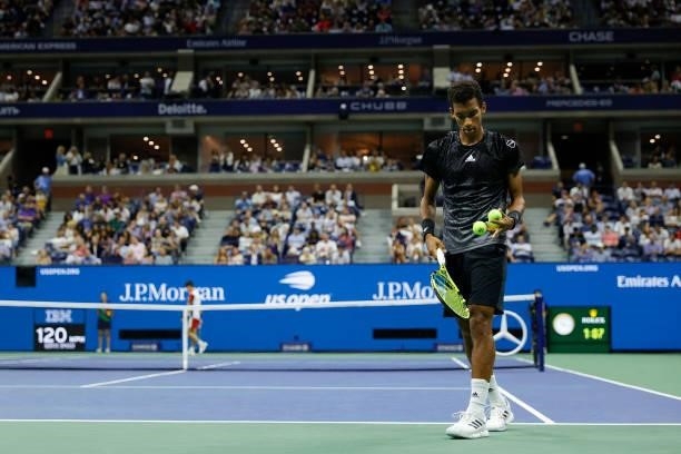 Felix Auger-Aliassime of Canada prepares to serve against Carlos Alcaraz of Spain during his Men’s Singles quarterfinals match on Day Nine of the...