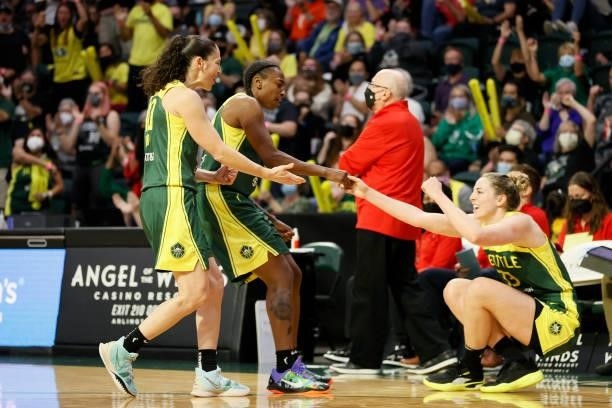 Sue Bird and Jewell Loyd help up Katie Lou Samuelson of the Seattle Storm after a foul on Samuelson's three point basket against the Washington...