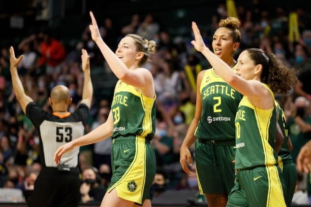 Katie Lou Samuelson, Mercedes Russell and Sue Bird of the Seattle Storm high five during the third quarter against the Washington Mystics at Angel of...