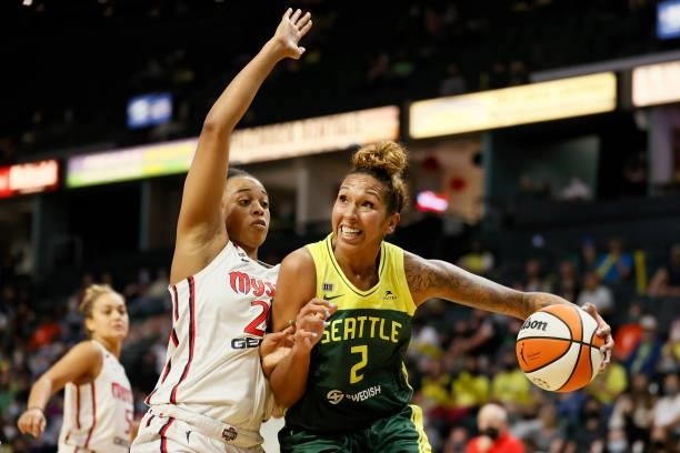 Erica McCall of the Washington Mystics defends Mercedes Russell of the Seattle Storm during the third quarter at Angel of the Winds Arena on...