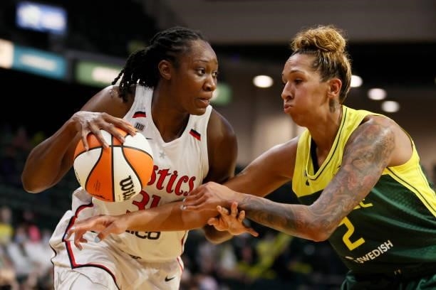 Tina Charles of the Washington Mystics dribbles against Mercedes Russell of the Seattle Storm during the second quarter at Angel of the Winds Arena...