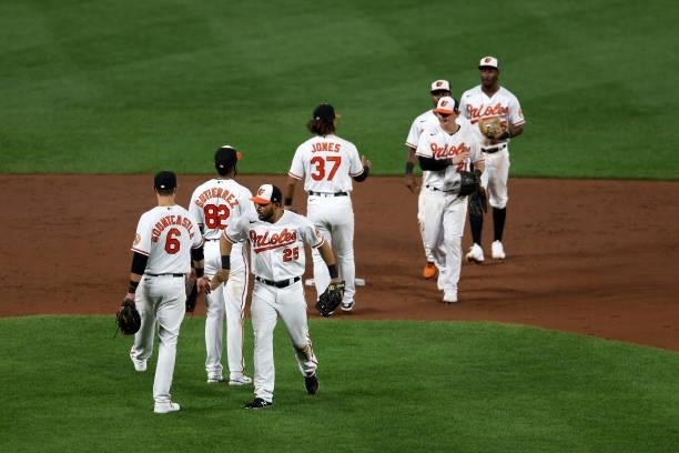 Members of the Baltimore Orioles celebrate their 7-3 win over the Kansas City Royals at Oriole Park at Camden Yards on September 07, 2021 in...