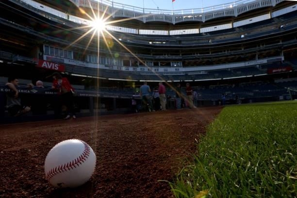 Baseball sits on the warning track during batting practice before a game between the Toronto Blue Jays and New York Yankees at Yankee Stadium on...