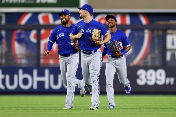 Outfielders Teoscar Hernandez, Randal Grichuk and Jarrod Dyson of the Toronto Blue Jays celebrate after defeating the New York Yankees 5-1 in a game...