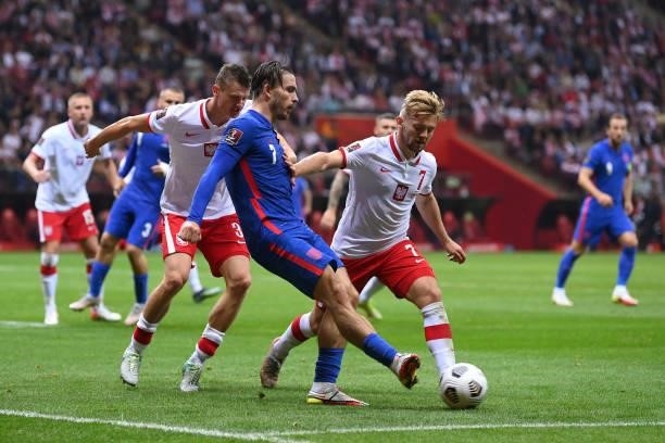 Jack Grealish of England is challenged by Kamil Jozwiak of Poland during the 2022 FIFA World Cup Qualifier match between Poland and England at...