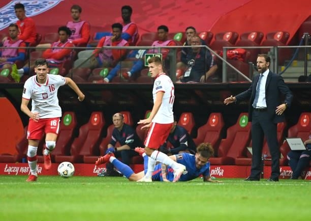 Gareth Southgate, Head Coach of England watches on as Kalvin Phillips of England is dispossessed by Jakub Moder of Poland during the 2022 FIFA World...