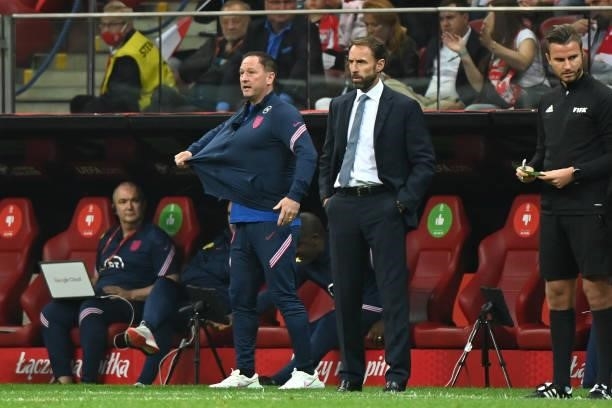Gareth Southgate, Head Coach of England and Steve Holland, Assistant Head Coach look on during the 2022 FIFA World Cup Qualifier match between Poland...