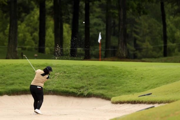 Ai Suzuki of Japan hits out from a bunker on the 6th hole during the first round of the JLPGA Championship Konica Minolta Cup at Shizu Hills Country...
