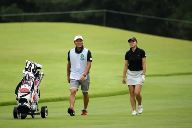 Emi Sato of Japan and her caddie Katsumasa Miyamoto talk on the 9th fairway during the first round of the JLPGA Championship Konica Minolta Cup at...