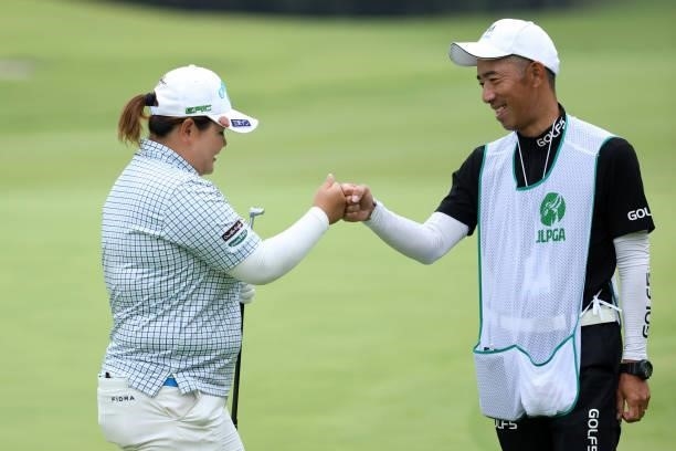 Maaya Suzuki of Japan fist bumps with her caddie after holing out on the 9th green during the first round of the JLPGA Championship Konica Minolta...
