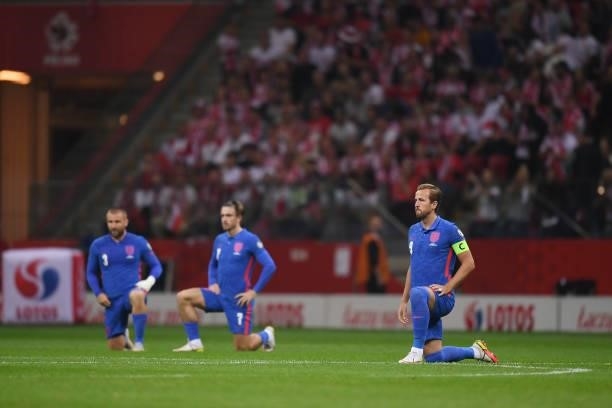 Luke Shaw, Jack Grealish and Harry Kane of England take the knee before the 2022 FIFA World Cup Qualifier between Poland and England at Stadion...