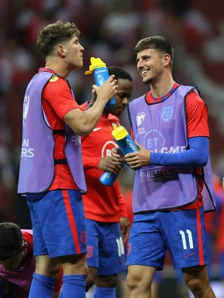 John Stones and Mason Mount of England drink from Lucozade bottles against Poland at Stadion Narodowy on September 08, 2021 in Warsaw, Poland.