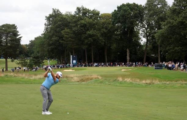 Tyrrell Hatton of England plays his second shot on the 15th hole during the first round of The BMW PGA Championship at Wentworth Golf Club on...