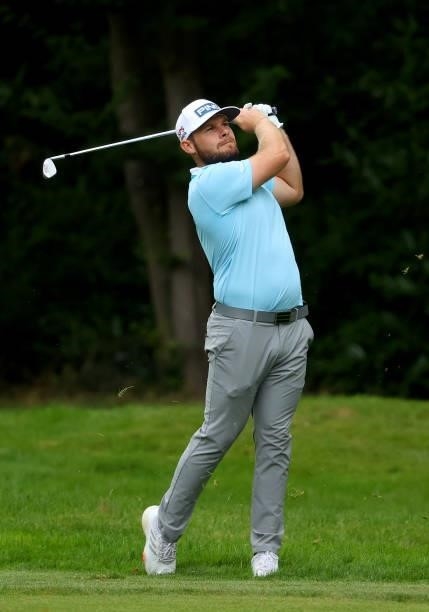 Tyrrell Hatton of England plays his second shot on the 16th hole during the first round of The BMW PGA Championship at Wentworth Golf Club on...