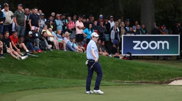 Robert McIntyre of Scotland looks on, after making a putt on the 18th green during Day One of The BMW PGA Championship at Wentworth Golf Club on...