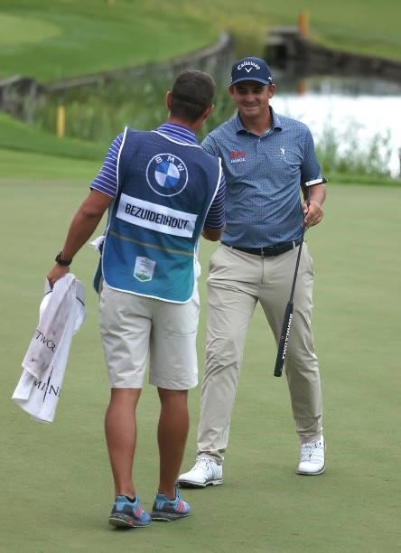 Christiaan Bezuidenhout of South Africa pictured with his caddie, after he finishes his round during Day One of The BMW PGA Championship at Wentworth...