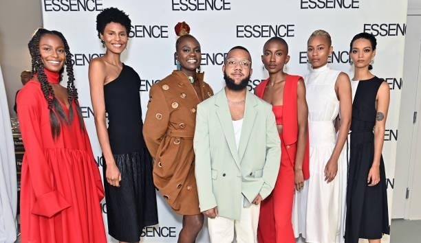 Arc of Andre designer Andre Moses poses for a photo with Caroline Wanga and models during the ESSENCE Fashion House - Red Carpet on September 09,...