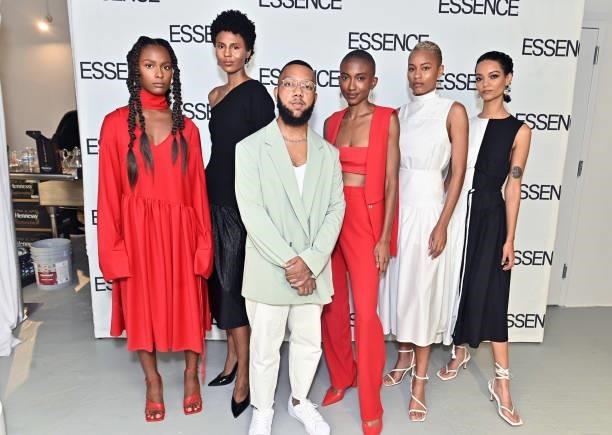 Arc of Andre designer Andre Moses poses for a photo with models during the ESSENCE Fashion House - Red Carpet on September 09, 2021 in New York City.