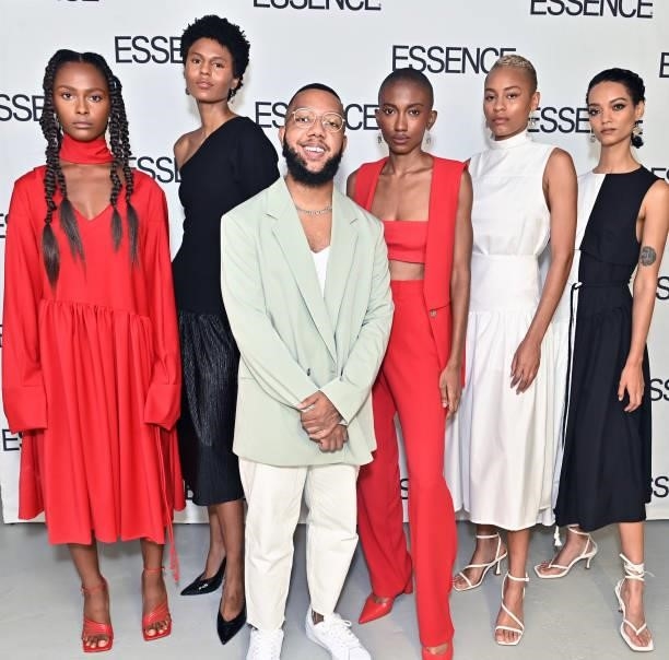 Arc of Andre designer Andre Moses poses for a photo with models during the ESSENCE Fashion House - Red Carpet on September 09, 2021 in New York City.