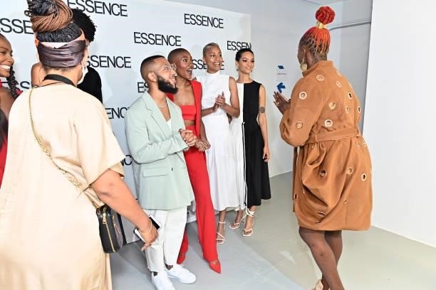 Arc of Andre designer Andre Moses and models greet Caroline Wanga of ESSENCE during the ESSENCE Fashion House - Red Carpet on September 09, 2021 in...
