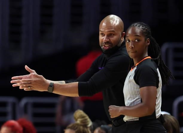 Head coach Derek Fisher of the Los Angeles Sparks with WNBA umpire Karleena Tobin in the second quarter at Staples Center on September 09, 2021 in...