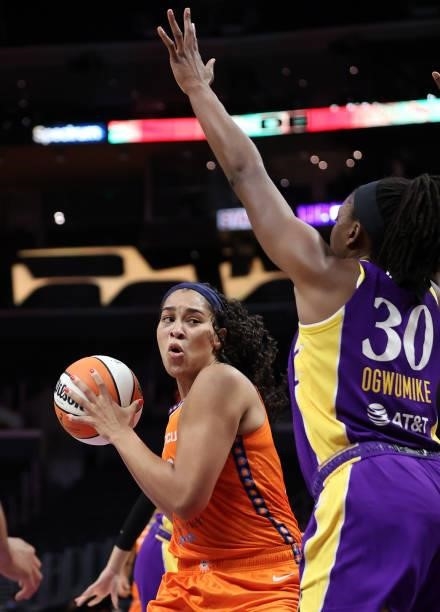 Brionna Jones of the Connecticut Sun controls the ball against Nneka Ogwumike of the Los Angeles Sparks in the second quarter at Staples Center on...