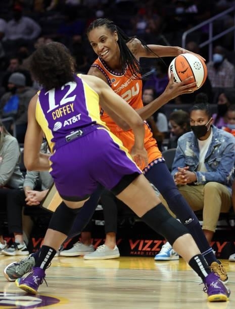DeWanna Bonner of the Connecticut Sun controls the ball against Nia Coffey of the Los Angeles Sparks in the first quarter at Staples Center on...