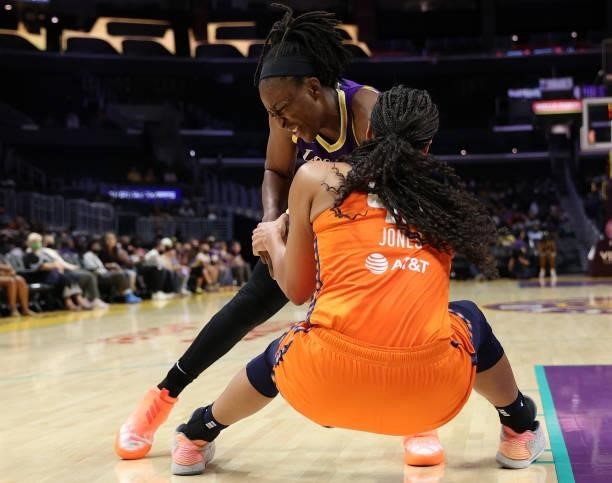 Brionna Jones of the Connecticut Sun ties up the ball with Nneka Ogwumike of the Los Angeles Sparks in the fourth quarter at Staples Center on...