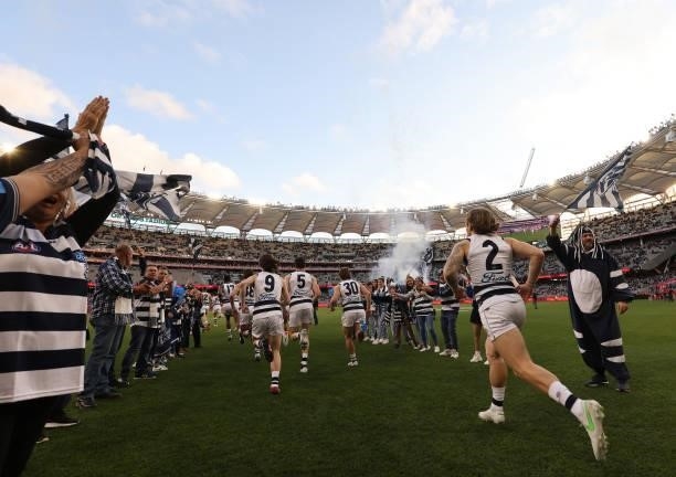 The Cats run out during the AFL First Preliminary Final match between Melbourne Demons and Geelong Cats at Optus Stadium on September 10, 2021 in...