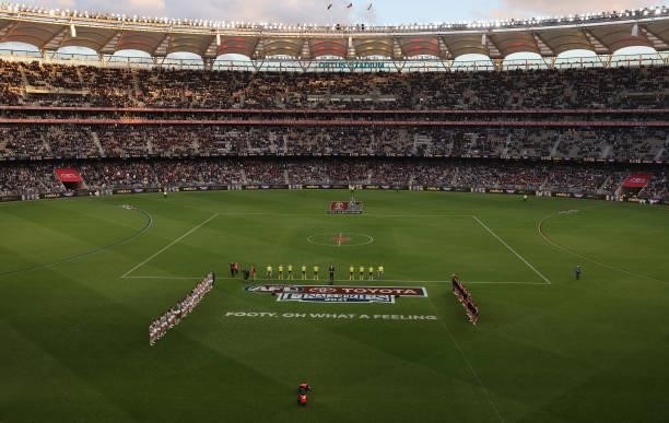 The teams and umpires line up during the AFL First Preliminary Final match between Melbourne Demons and Geelong Cats at Optus Stadium on September...