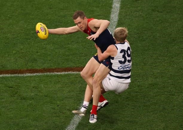 Tom McDonald of the Demons is challenged by Zach Guthrie of the Cats during the AFL First Preliminary Final match between Melbourne Demons and...