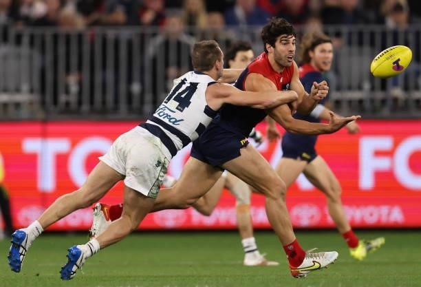 Christian Petracca of the Demons is challenged by Joel Selwood of the Cats during the AFL First Preliminary Final match between Melbourne Demons and...