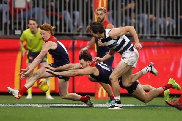 Jake Bowey and Michael Hibberd of the Demons smother a shot on goal by Isaac Smith of the Cats during the AFL First Preliminary Final match between...
