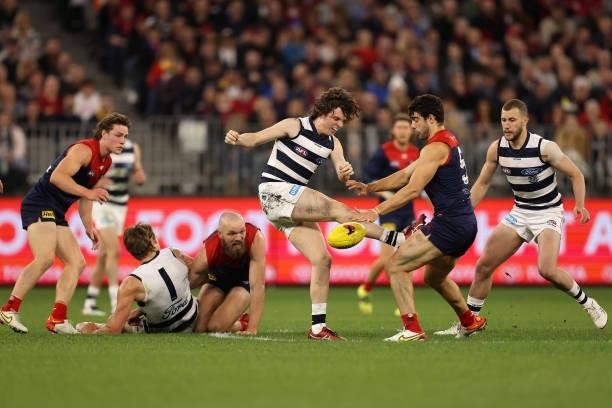 Christian Petracca of the Demons smothers the kick by Max Holmes of the Cats during the AFL First Preliminary Final match between the Melbourne...