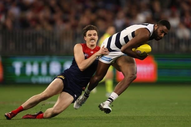 Esava Ratugolea of the Cats gets tackled by Jake Lever of the Demons during the AFL First Preliminary Final match between the Melbourne Demons and...
