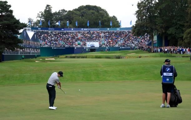 Justin Rose of England plays his second shot into the 18th green during the second round of The BMW PGA Championship at Wentworth Golf Club on...