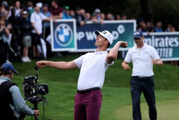 Victor Perez of France throws his ball into the crowd after his round, watched by Martin Kaymer of Germany during Day Two of The BMW PGA Championship...