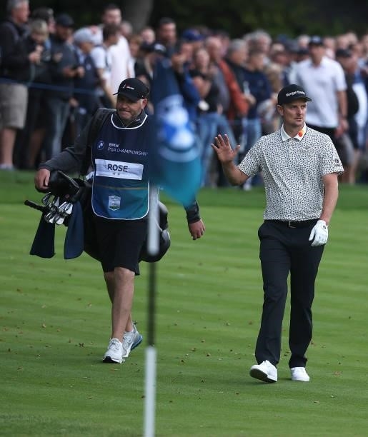 Justin Rose of England walks up the 18th fairway acknowledging the crowd during Day Two of The BMW PGA Championship at Wentworth Golf Club on...