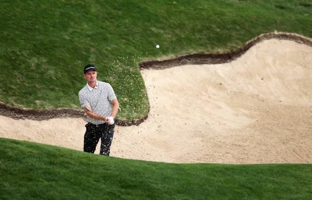 Justin Rose of England plays out of a bunker on the 18th hole during Day Two of The BMW PGA Championship at Wentworth Golf Club on September 10, 2021...