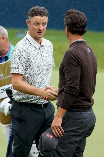 Justin Rose of England and Adam Scott of Australia on the 18th green during the second round of The BMW PGA Championship at Wentworth Golf Club on...