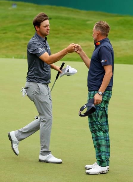 Bernd Wiesberger of Austria and Ian Poulter of England on the 18th hole during the second round of The BMW PGA Championship at Wentworth Golf Club on...