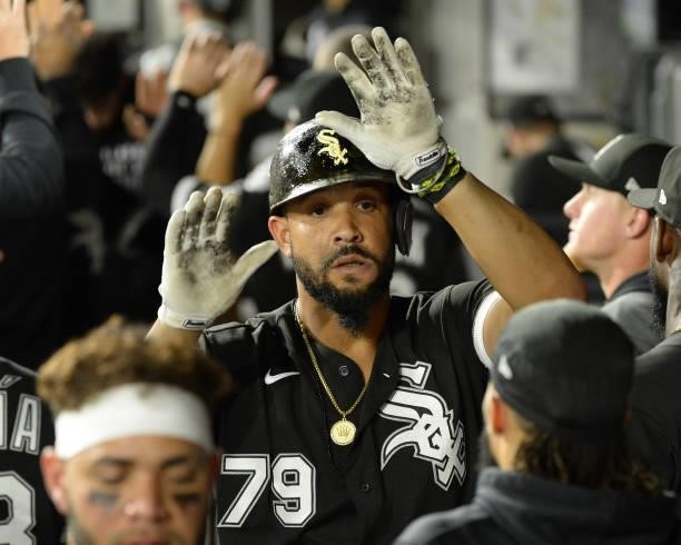 Jose Abreu of the Chicago White Sox celebrates with teammates after hitting a three-run home run in the third inning against the Boston Red Sox on...