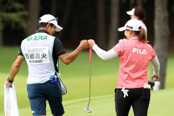 Mao Saigo of Japan fist bumps with her caddie after the birdie on the 5th green during the third round of the JLPGA Championship Konica Minolta Cup...