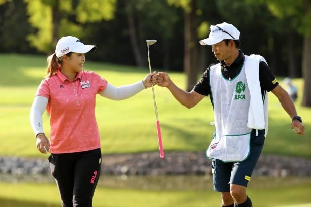 Mao Saigo of Japan fist bumps with her caddie after the birdie on the 17th green during the third round of the JLPGA Championship Konica Minolta Cup...