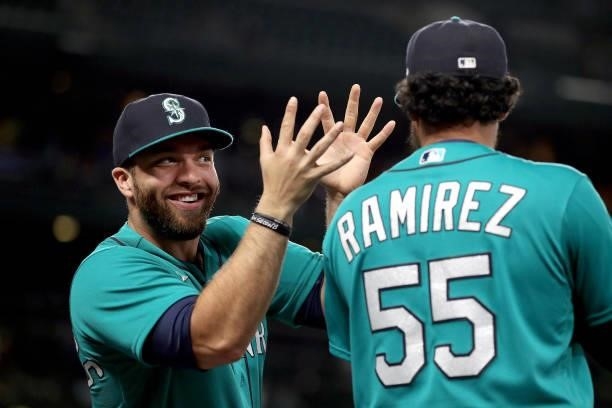 Jose Marmolejos claps into the face of Yohan Ramirez of the Seattle Mariners before the game against the Arizona Diamondbacks at T-Mobile Park on...