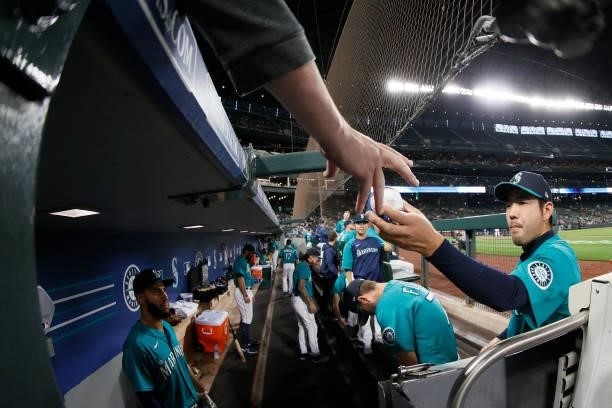 Yusei Kikuchi of the Seattle Mariners signs autographs before the game against the Arizona Diamondbacks at T-Mobile Park on September 10, 2021 in...
